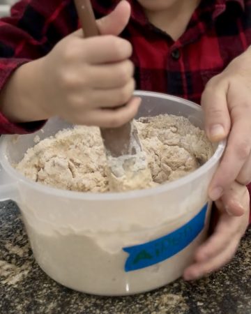 Child mixing bread dough