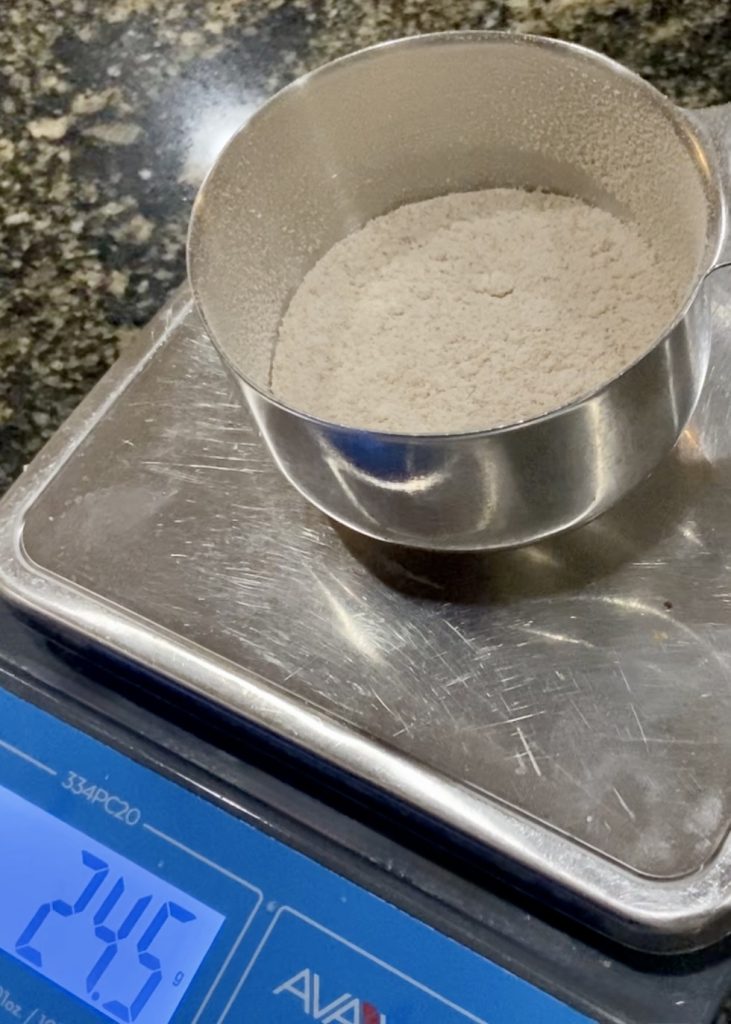 Flour in a measuring cup on a scale
