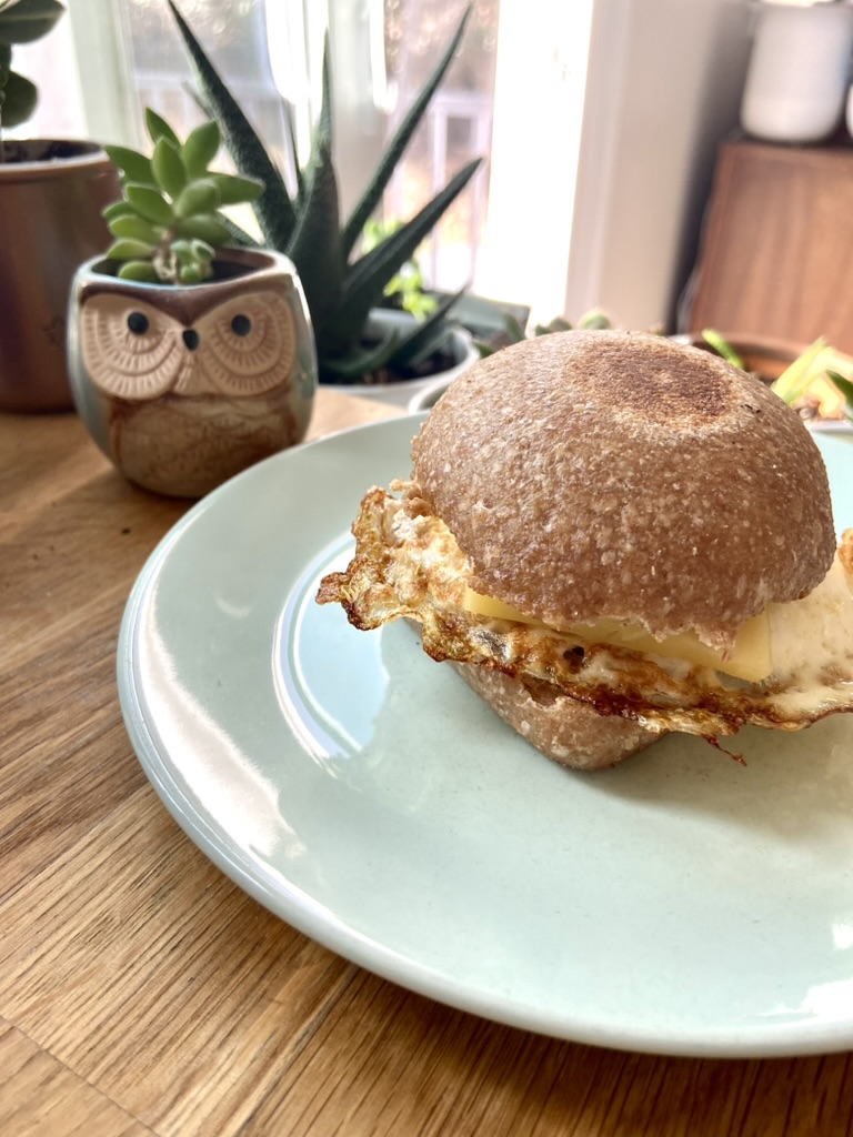 Breakfast sandwich with egg and cheese sitting on a plate