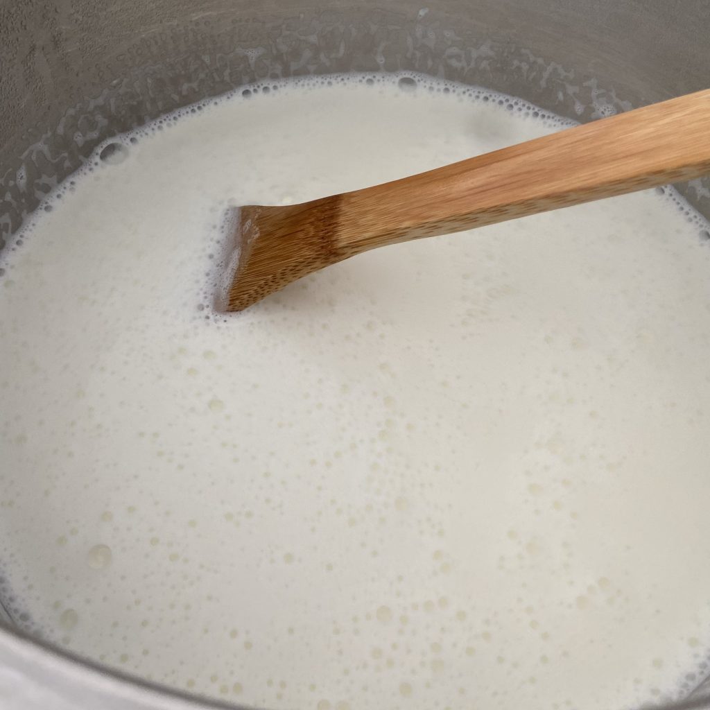 Foamy hot milk in an instant pot that has just started to boil